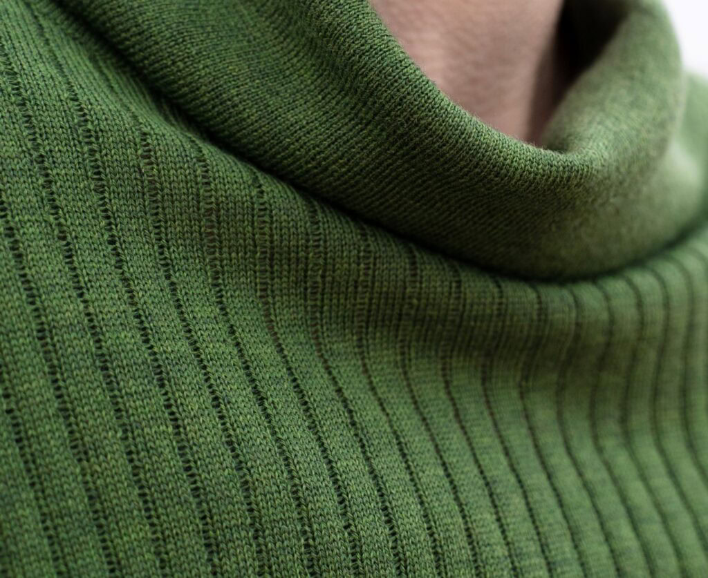 Green knitted turtleneck sweater. High quality products.