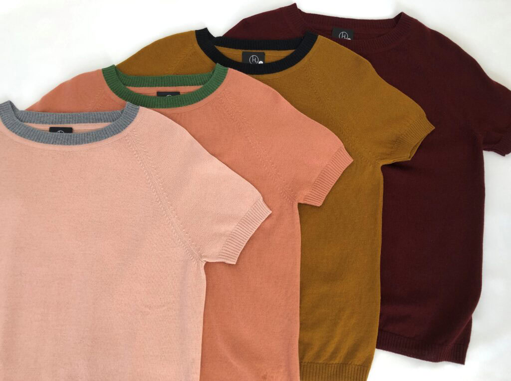 Various colored Hanne Linding knit sweaters with short sleeves and contrasting neckline.