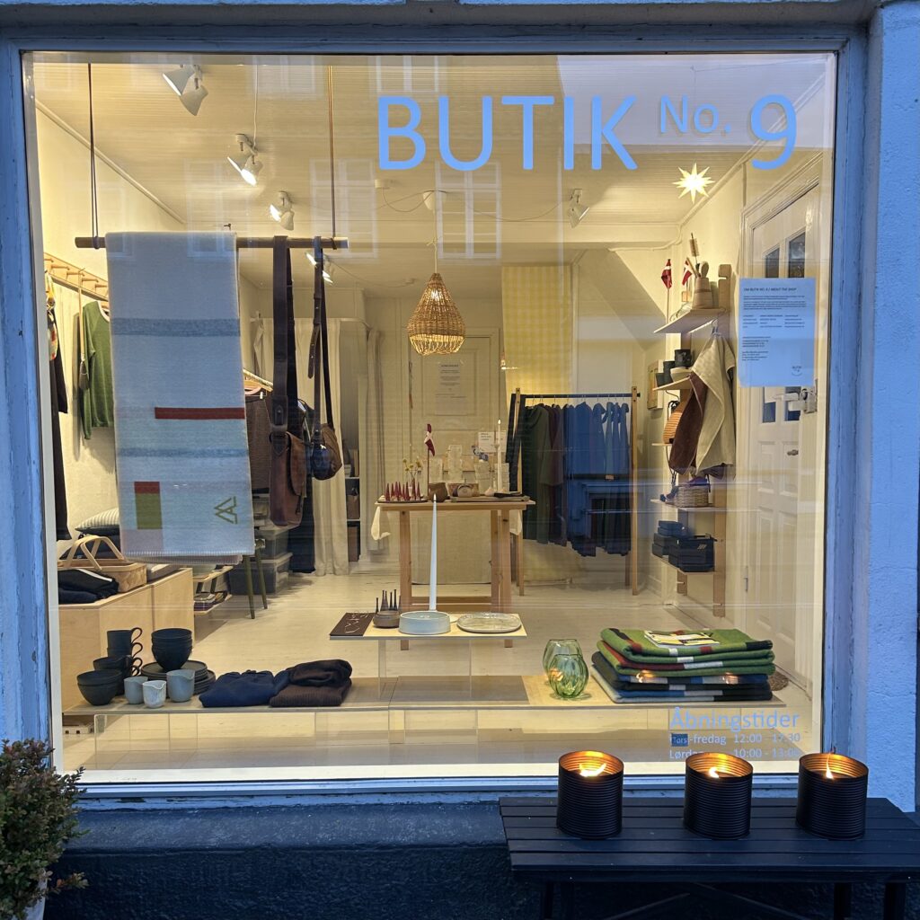 Shop No. 9 window with handmade goods and cozy lighting. News in the shop!